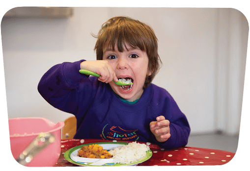 child eating at nursery