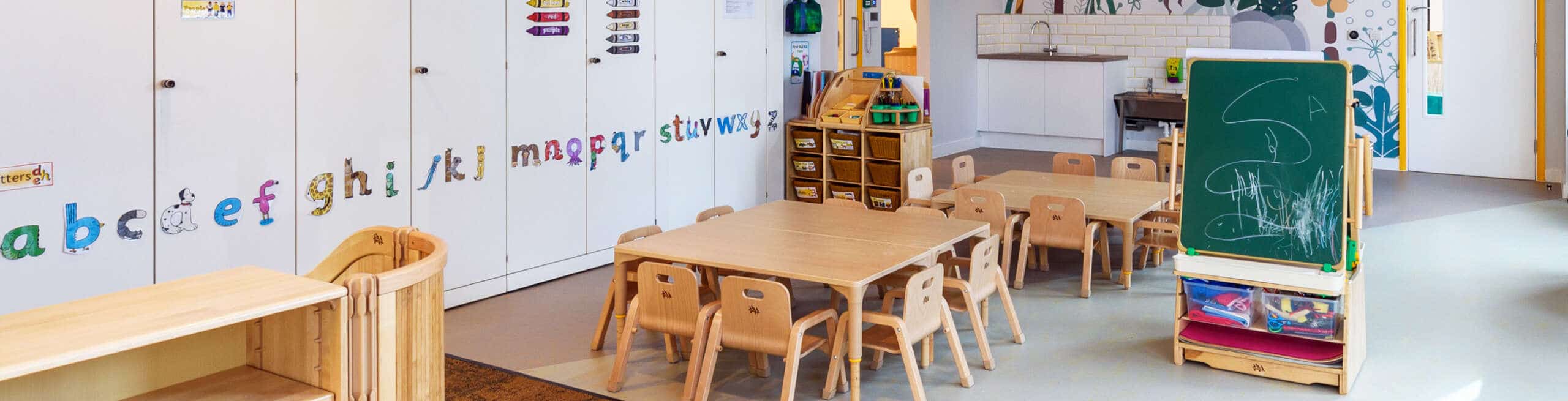 Childrens daycare interior wooden tables and chalkboard cover image